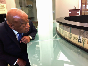 John Lewis studies his own photo in a civil rights timeline at the Nashville Public Library